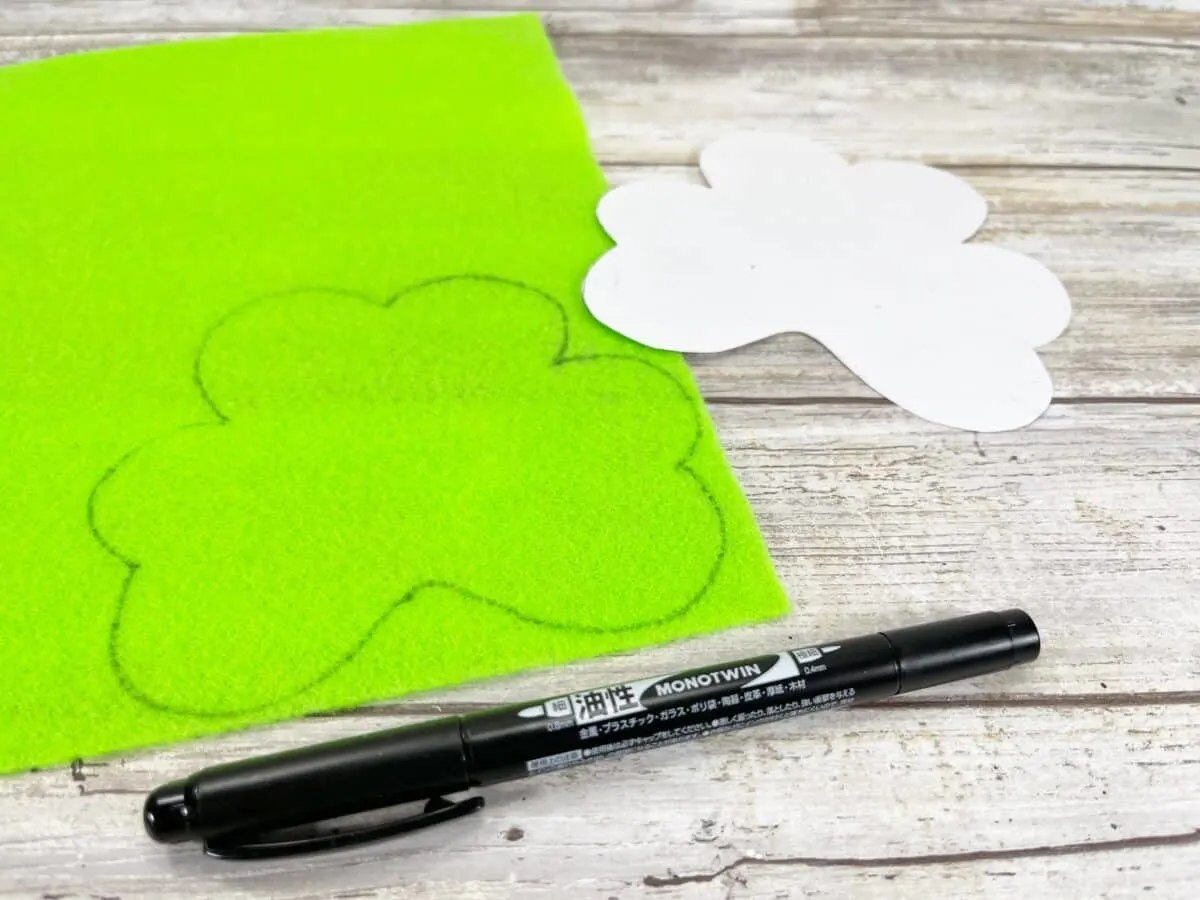 A green piece of felt with shamrocks and a marker.