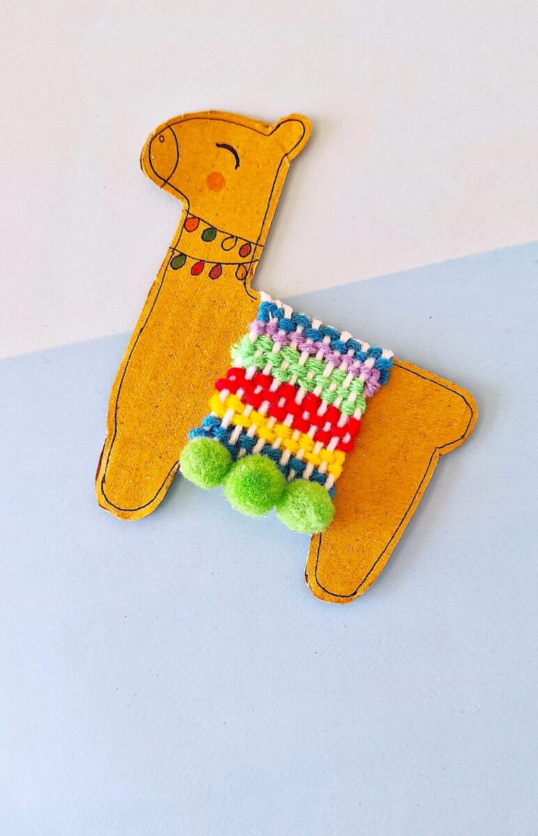 Llama Craft with colorful pom poms on a blue background.