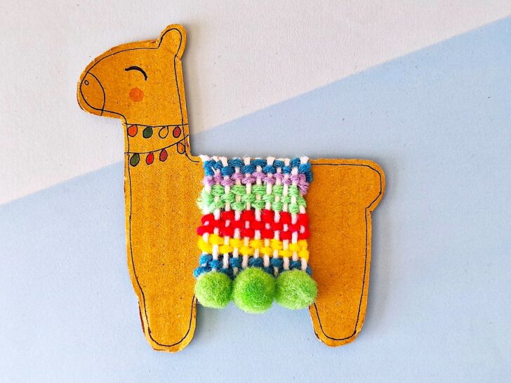 Llama Craft with colorful pom poms hanging from it.