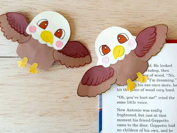 Bald Eagle Bookmarks placed on an open book sitting on a wooden table top.