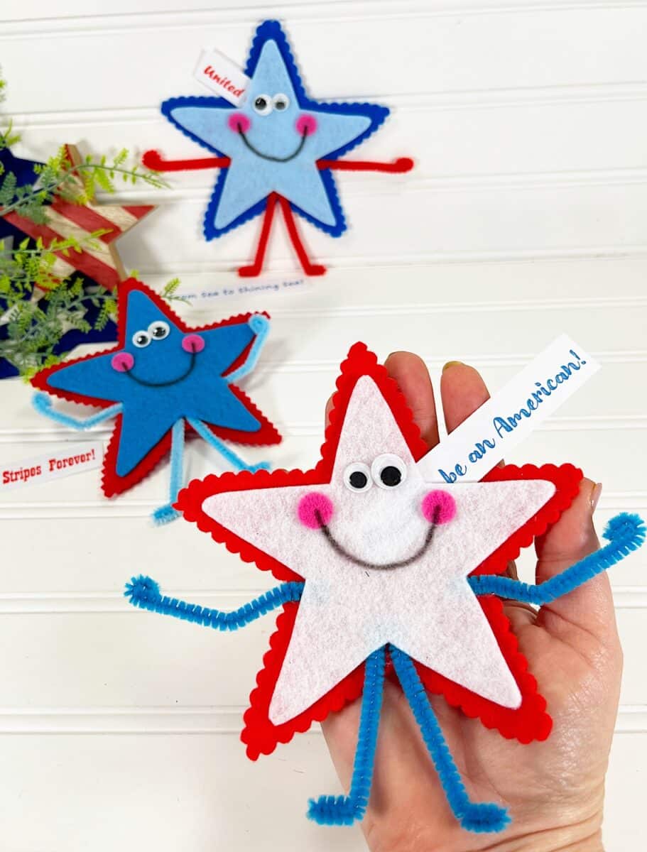 Felt Star People A hand holding a decorative star-shaped craft with a smiling face, alongside similar crafts with patriotic american themes.