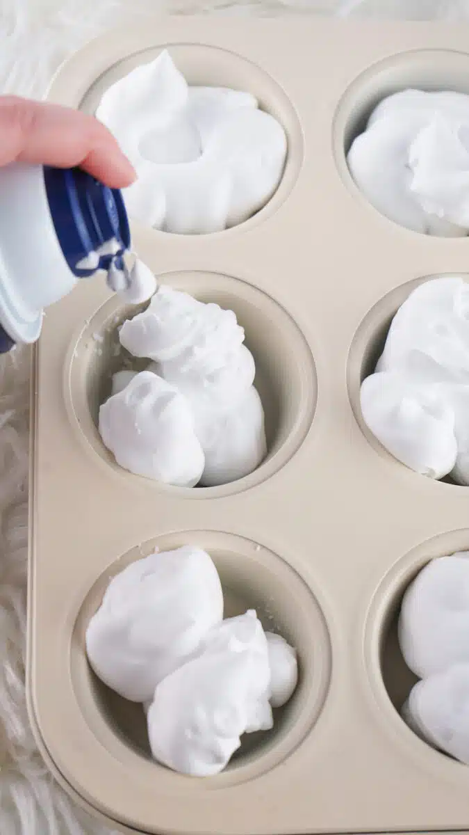 Dispensing shaving cream into a muffin tin.