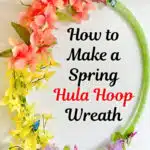A colorful spring hula hoop wreath adorned with flowers and butterflies, with a caption "how to create a spring hula hoop wreath" from singlegirlsdiy.com.