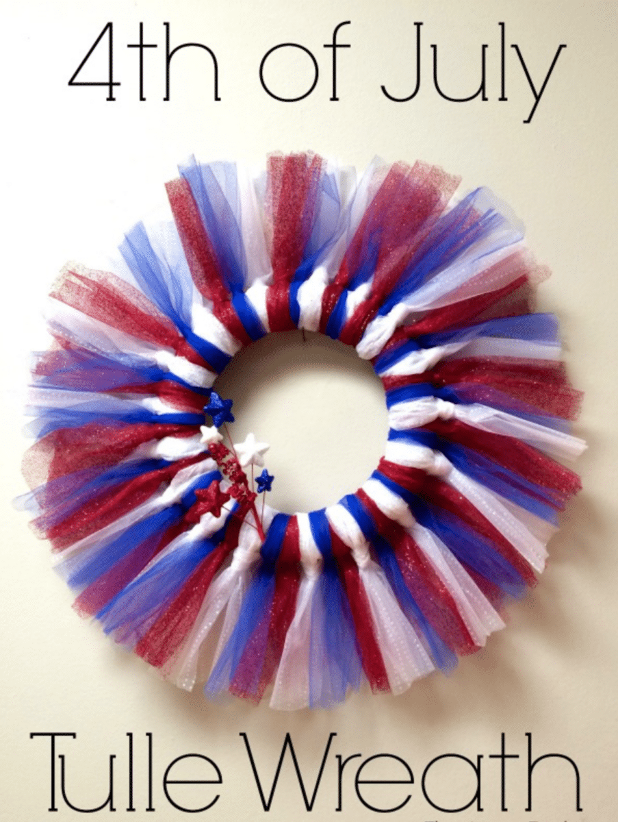 A festive red, white, and blue tulle wreath decorated with stars, commemorating the Fourth of July.