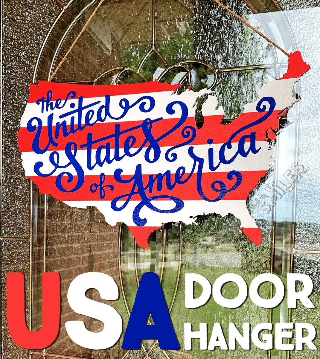 Decorative usa-shaped door hanger with a patriotic design.