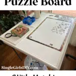 A puzzle board with an in-progress puzzle is shown on a table, accompanied by a matching tray holding puzzle pieces. The text reads, "How to Make a Puzzle Board with Matching Puzzle Piece Tray" from SingleGirlsDIY.com.