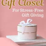 A pink background with a white gift box tied with a ribbon, placed on white boxes. Text reads: "Why You Need a Gift Closet for Stress-Free Gift Giving." SingleGirlsDIY.com.