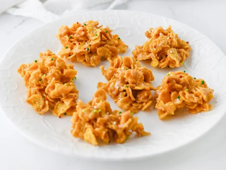 Plate of caramel cornflake clusters with colorful sprinkles.