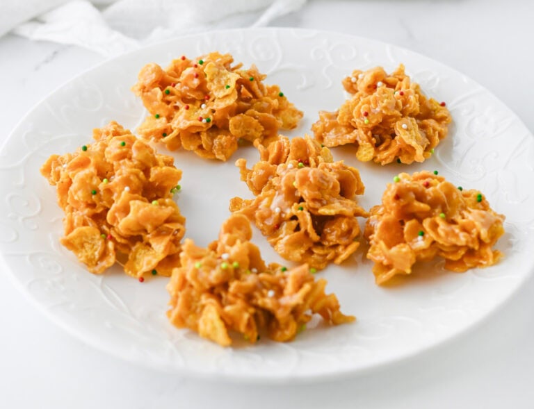 Plate of caramel cornflake clusters with colorful sprinkles.
