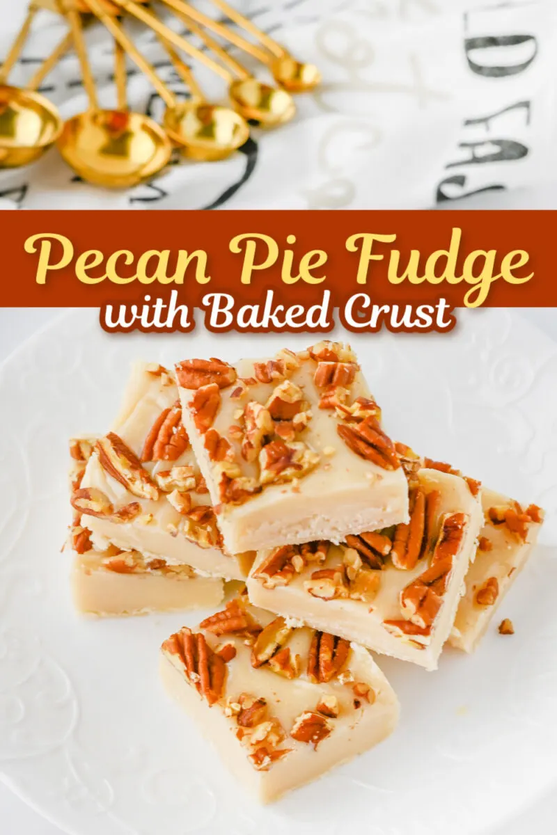 Stacked squares of pecan pie fudge, complete with a baked crust and topped with crunchy pecan pieces, adorn a white plate. In the background, golden measuring spoons add a touch of elegance.