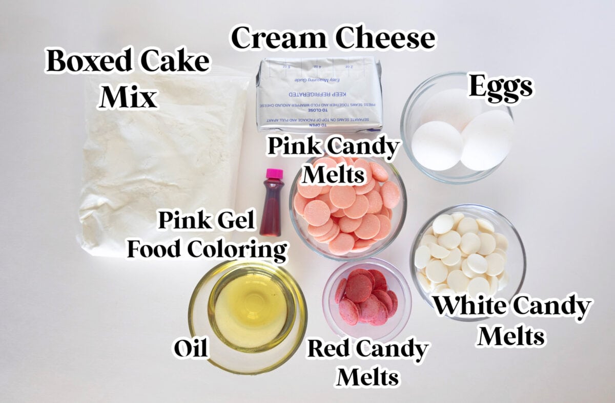 Ingredients for Valentine cake truffles: boxed cake mix, cream cheese, eggs, oil, pink gel food coloring, and a love-inspired trio of pink, red, and white candy melts.