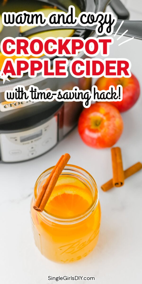 Jar of crockpot apple cider with cinnamon sticks and orange slice in front of a crockpot and apples, with text: “Warm and cozy crockpot apple cider with time-saving hack!”.