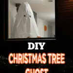 A white sheet with cut-out eyes draped over a Christmas tree creates a ghost figure in a window, promoting a DIY Halloween decoration idea.