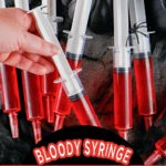 Several plastic syringes filled with red Jell-O are arranged on a dark fabric, with one hand holding a syringe. Text reads, "Syringe Jello Shots Bloody Syringe Jell-O Shots SingleGirlsDIY.com.
