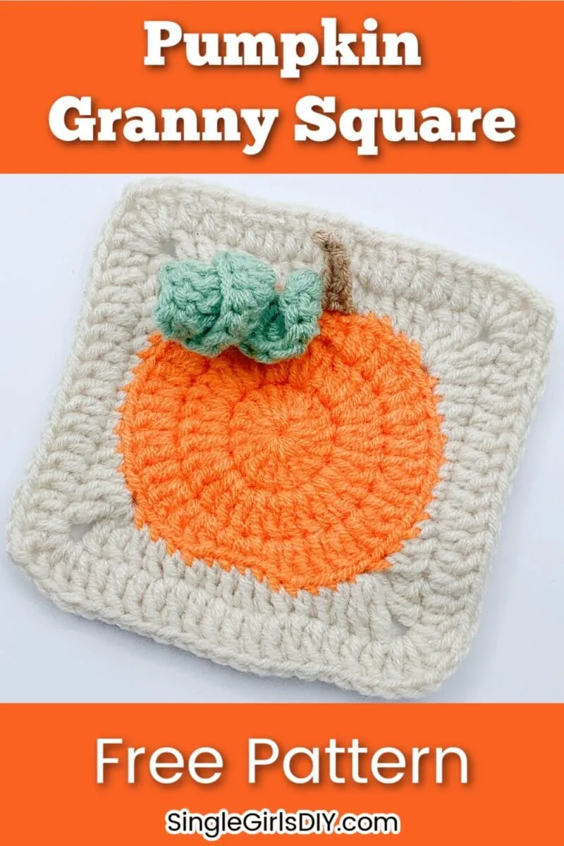 Crocheted granny square featuring an orange pumpkin with a green stem on a cream background. Text reads "Pumpkin Granny Square Free Pattern SingleGirlsDIY.com".